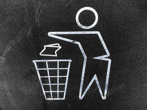 Cartoon person tossing trash into bin